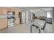 Modern kitchen with stainless steel appliances, wooden cabinets, and a dining area adjacent to the living room at 2586 Begonia Valley Ave, Henderson, NV 89074