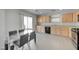 Open kitchen with stainless appliances, wood cabinets, and adjacent dining area leading to a patio at 2586 Begonia Valley Ave, Henderson, NV 89074