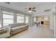 Bright living room with large windows flows seamlessly into a kitchen with wooden cabinets at 2586 Begonia Valley Ave, Henderson, NV 89074
