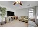 Cozy living room featuring tile floors, neutral walls, a ceiling fan, and comfortable furniture for relaxation at 2586 Begonia Valley Ave, Henderson, NV 89074