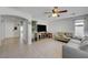 Open living room boasts tile floors, neutral walls, and comfortable seating arrangements beneath a ceiling fan at 2586 Begonia Valley Ave, Henderson, NV 89074
