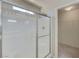 Modern glass shower with tile surround and a walk in closet at 2586 Begonia Valley Ave, Henderson, NV 89074