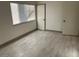 Bedroom with wood-look floors and bright window at 2692 Matogroso Ln, Las Vegas, NV 89121