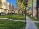 View of the townhome complex featuring lawns, sidewalks and mature landscaping at 2692 Matogroso Ln, Las Vegas, NV 89121