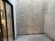 Private outdoor patio with textured walls and sliding glass door access to the interior at 2692 Matogroso Ln, Las Vegas, NV 89121