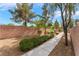 A block wall surrounds a yard that is xeriscaped with bushes, mulch and rock at 28 Yellow Flame Ave, North Las Vegas, NV 89084