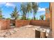 The fenced backyard features a low maintenance rock garden, providing a private space at 28 Yellow Flame Ave, North Las Vegas, NV 89084