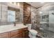 Bathroom features stone wall accents, glass shower, and vanity at 28 Yellow Flame Ave, North Las Vegas, NV 89084