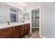Bright bathroom featuring dual sinks with modern fixtures and a walk-in closet at 28 Yellow Flame Ave, North Las Vegas, NV 89084