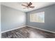 Bedroom with ceiling fan, window, and plank flooring at 28 Yellow Flame Ave, North Las Vegas, NV 89084