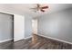 Bedroom with ceiling fan, closet, and wood-look flooring at 28 Yellow Flame Ave, North Las Vegas, NV 89084
