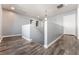Upstairs landing area featuring modern light fixtures and wood-style flooring at 28 Yellow Flame Ave, North Las Vegas, NV 89084