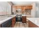 Kitchen area with stainless steel gas range and oven and mosaic tile backsplash at 28 Yellow Flame Ave, North Las Vegas, NV 89084