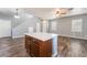 Open-concept kitchen area featuring an island with a white countertop and wooden cabinets at 28 Yellow Flame Ave, North Las Vegas, NV 89084
