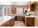 Kitchen with sliding glass door to patio and mosaic tile backsplash at 28 Yellow Flame Ave, North Las Vegas, NV 89084