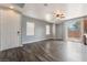 Open-concept living room featuring a ceiling fan, hardwood floors, and natural light at 28 Yellow Flame Ave, North Las Vegas, NV 89084