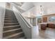 Open-concept living space with stairs leading to second floor and sliding doors to the outside at 28 Yellow Flame Ave, North Las Vegas, NV 89084