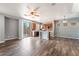 An open-concept area with modern ceiling fan, view to kitchen and sliding glass door to backyard at 28 Yellow Flame Ave, North Las Vegas, NV 89084