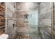 Modern tiled shower with glass door and pebble floor at 28 Yellow Flame Ave, North Las Vegas, NV 89084