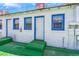 Clean white exterior featuring bright blue trim, green-painted steps, and convenient back entrances at 300 N 14Th St, Las Vegas, NV 89101