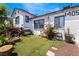 Private backyard featuring artificial turf, mature landscaping, and a charming seating area for outdoor relaxation at 300 N 14Th St, Las Vegas, NV 89101