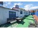 Backyard with green patio area, table and chairs, and white exterior walls at 300 N 14Th St, Las Vegas, NV 89101