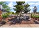 Serene backyard oasis with a cozy patio set, mature trees, and easy access to nearby amenities at 300 N 14Th St, Las Vegas, NV 89101