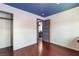 Cozy bedroom features wood floors, neutral walls, an accent painted ceiling, and a closet for storage at 300 N 14Th St, Las Vegas, NV 89101