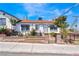Charming single-story home with a well-maintained front yard, brick accents, colorful flowers, and a secure fence at 300 N 14Th St, Las Vegas, NV 89101