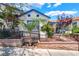Charming white-painted exterior with blue trim, beautiful garden, and secure fencing at 300 N 14Th St, Las Vegas, NV 89101
