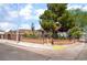 Charming single-story home featuring a decorative brick wall, lush trees, and inviting curb appeal at 300 N 14Th St, Las Vegas, NV 89101