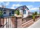 Delightful white-painted home with blue trim, well-kept garden, and secure wrought-iron fencing at 300 N 14Th St, Las Vegas, NV 89101