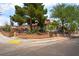Charming single-story home with a decorative brick wall, lush trees, and inviting curb appeal at 300 N 14Th St, Las Vegas, NV 89101