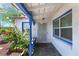 Inviting front porch with white door, blue trim, lovely plants, and tiled flooring at 300 N 14Th St, Las Vegas, NV 89101