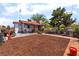 Charming home featuring a spacious front yard with desert landscaping, walkway, and comfortable outdoor seating area at 300 N 14Th St, Las Vegas, NV 89101
