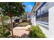 Quaint front yard showcasing a lush garden, brick path, and charming curb appeal with colorful flowers and greenery at 300 N 14Th St, Las Vegas, NV 89101