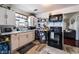 Traditional kitchen with bright cabinets, black appliances, and light tile flooring at 300 N 14Th St, Las Vegas, NV 89101