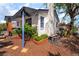 Charming home featuring desert landscaping, white exterior with blue trim, and flowerbeds along the perimeter at 300 N 14Th St, Las Vegas, NV 89101