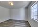 This bedroom features gray wood-look flooring, a window with a view and a ceiling light at 3318 N Decatur Blvd # 2138, Las Vegas, NV 89130