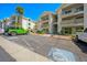 Exterior view of a well-kept condo complex with parking and tropical landscaping at 3550 Bay Sands Dr # 3006, Laughlin, NV 89029