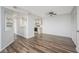 Living room with wood floors, view of kitchen and balcony, closet, and a ceiling fan at 3550 Bay Sands Dr # 3006, Laughlin, NV 89029