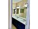 Bathroom with double sinks, vanity with blue cabinets, a large mirror and a shower/tub combination at 3729 La Junta Dr, Las Vegas, NV 89120