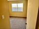 Bright bedroom with a neutral color scheme, carpet flooring, and a view of the backyard through a large window at 3729 La Junta Dr, Las Vegas, NV 89120