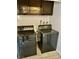 Laundry room with washer and dryer, as well as wooden cabinets for storage at 3729 La Junta Dr, Las Vegas, NV 89120