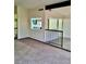 Open living area with neutral carpet and a railing, perfect for entertaining at 3729 La Junta Dr, Las Vegas, NV 89120