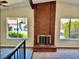 Upstairs living room with brick fireplace and exterior views through large windows at 3729 La Junta Dr, Las Vegas, NV 89120