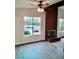 Bright living room featuring a brick fireplace and large window with neighborhood views at 3729 La Junta Dr, Las Vegas, NV 89120