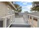 Backyard view of the home with a well-maintained wooden deck and white railing at 3936 Applecrest St, Las Vegas, NV 89108