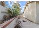 The side yard features a block wall, small palm tree, and concrete patio area at 3936 Applecrest St, Las Vegas, NV 89108