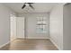 Bright bedroom with wood-look floors, neutral walls, ceiling fan, and window at 3936 Applecrest St, Las Vegas, NV 89108
